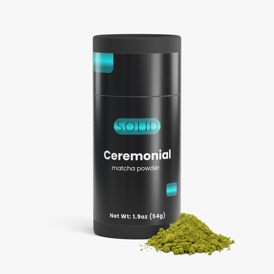 Solid Health Ceremonial Matcha tube with a small pile of ceremonial matcha powder in front
